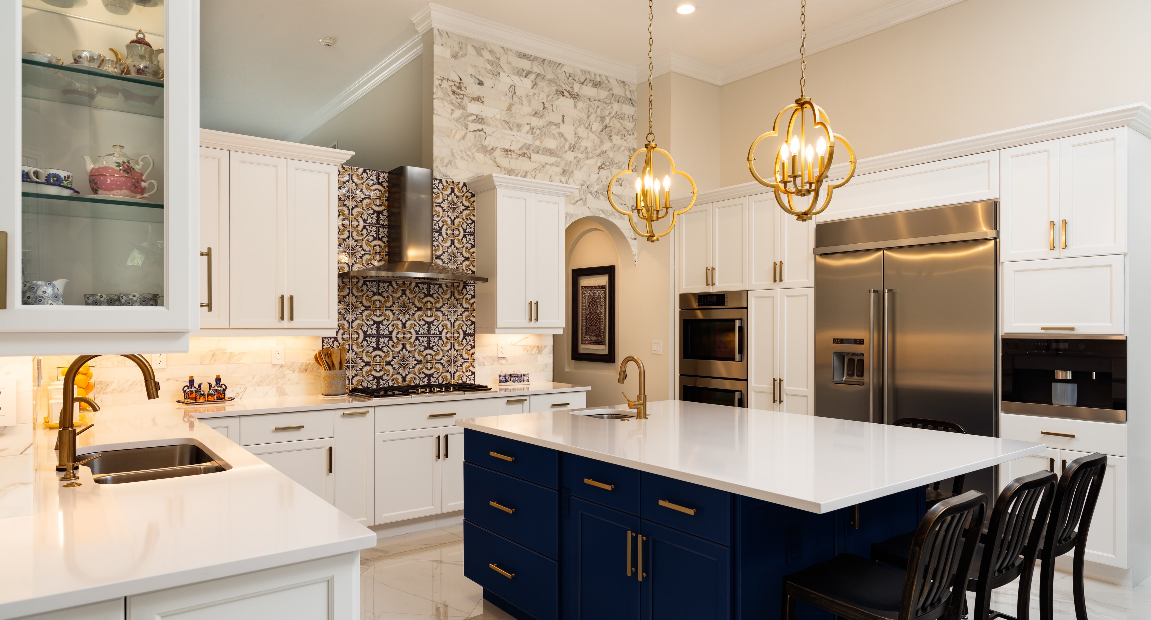 Custom navy and gold kitchen with marble island